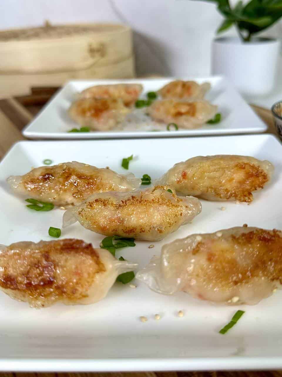 Pan fried shrimp dumplings on a white plate