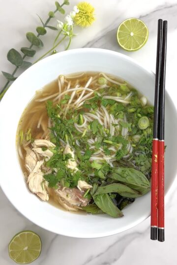 Bowl of Vietnamese chicken noodle soup with chopsticks