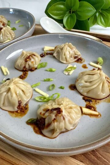 Pork soup dumplings on a plate with chili oil