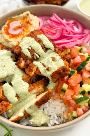 Harissa Honey Chicken in a bowl with lemon herb tahini featured angle