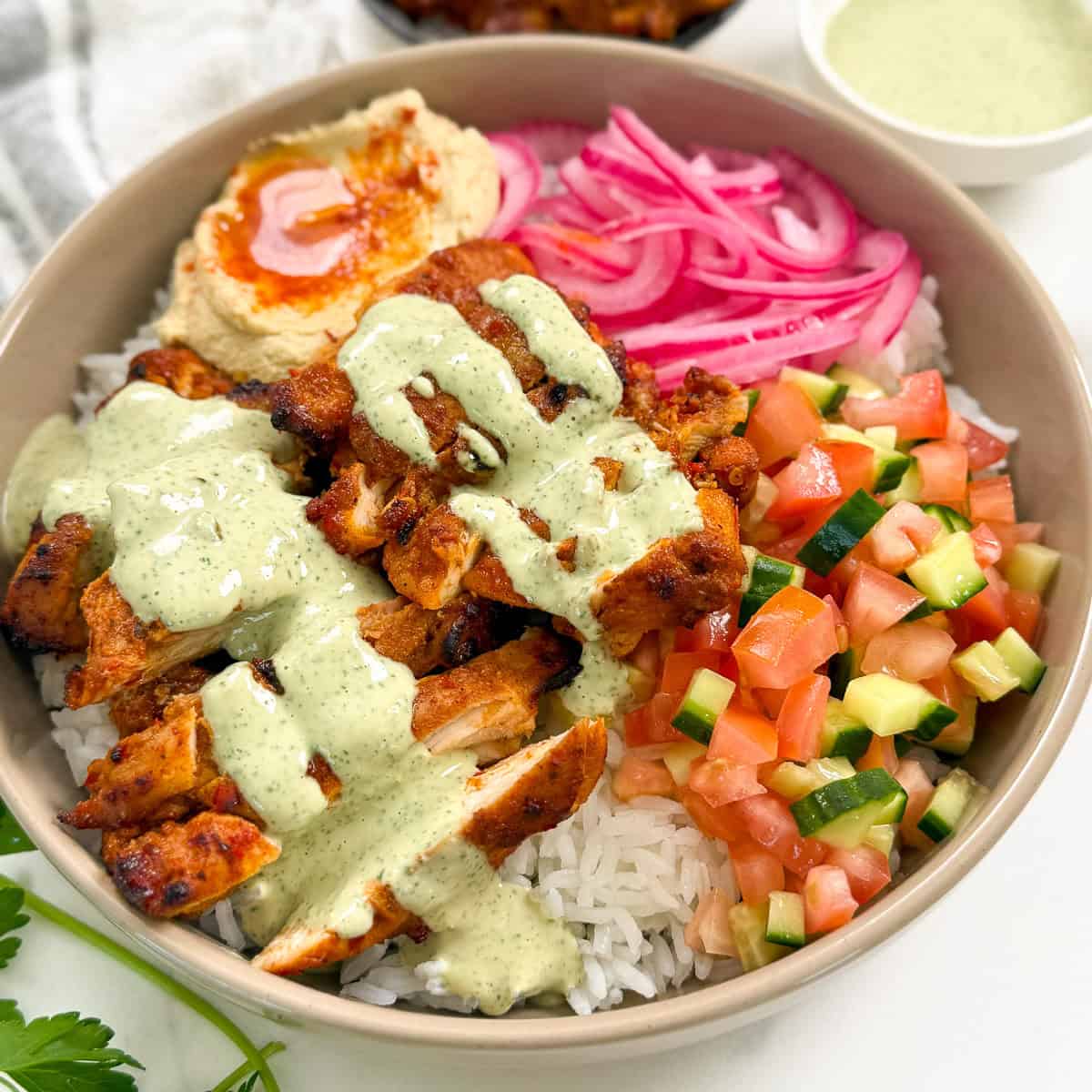 Harissa Honey Chicken in a bowl with lemon herb tahini featured angle