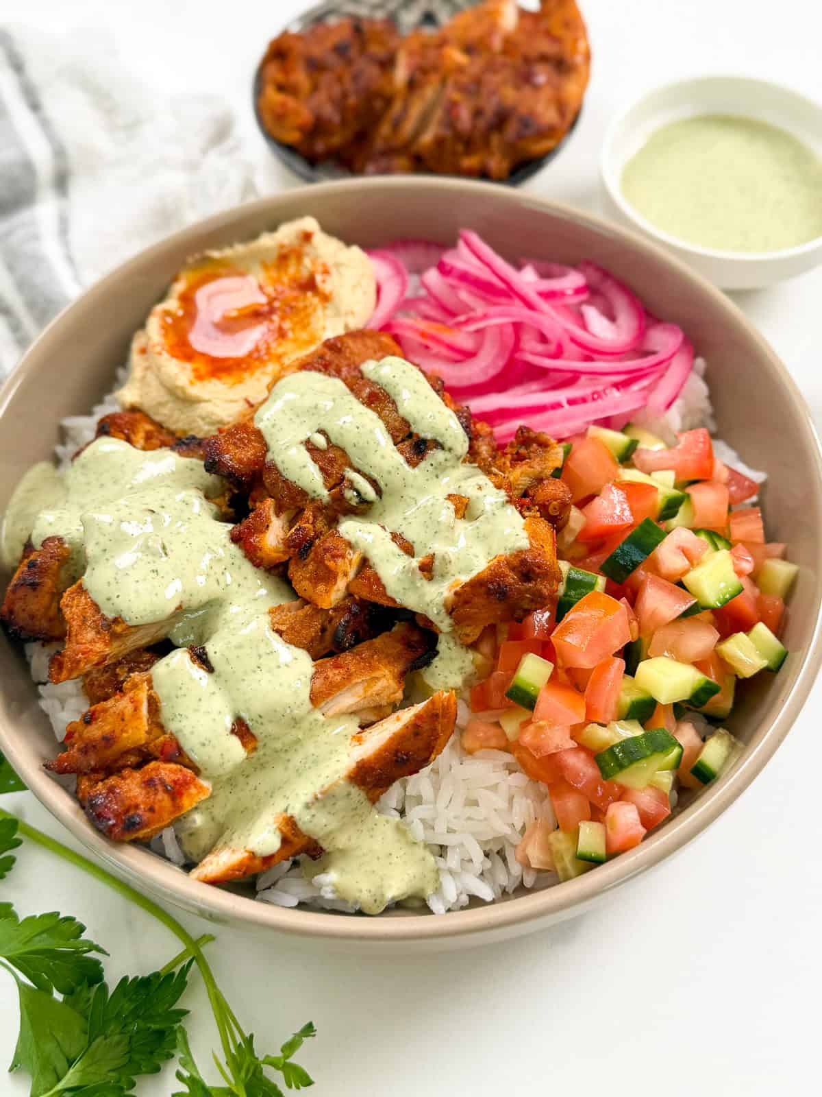 Harissa Honey Chicken in a bowl with lemon herb tahini main angle
