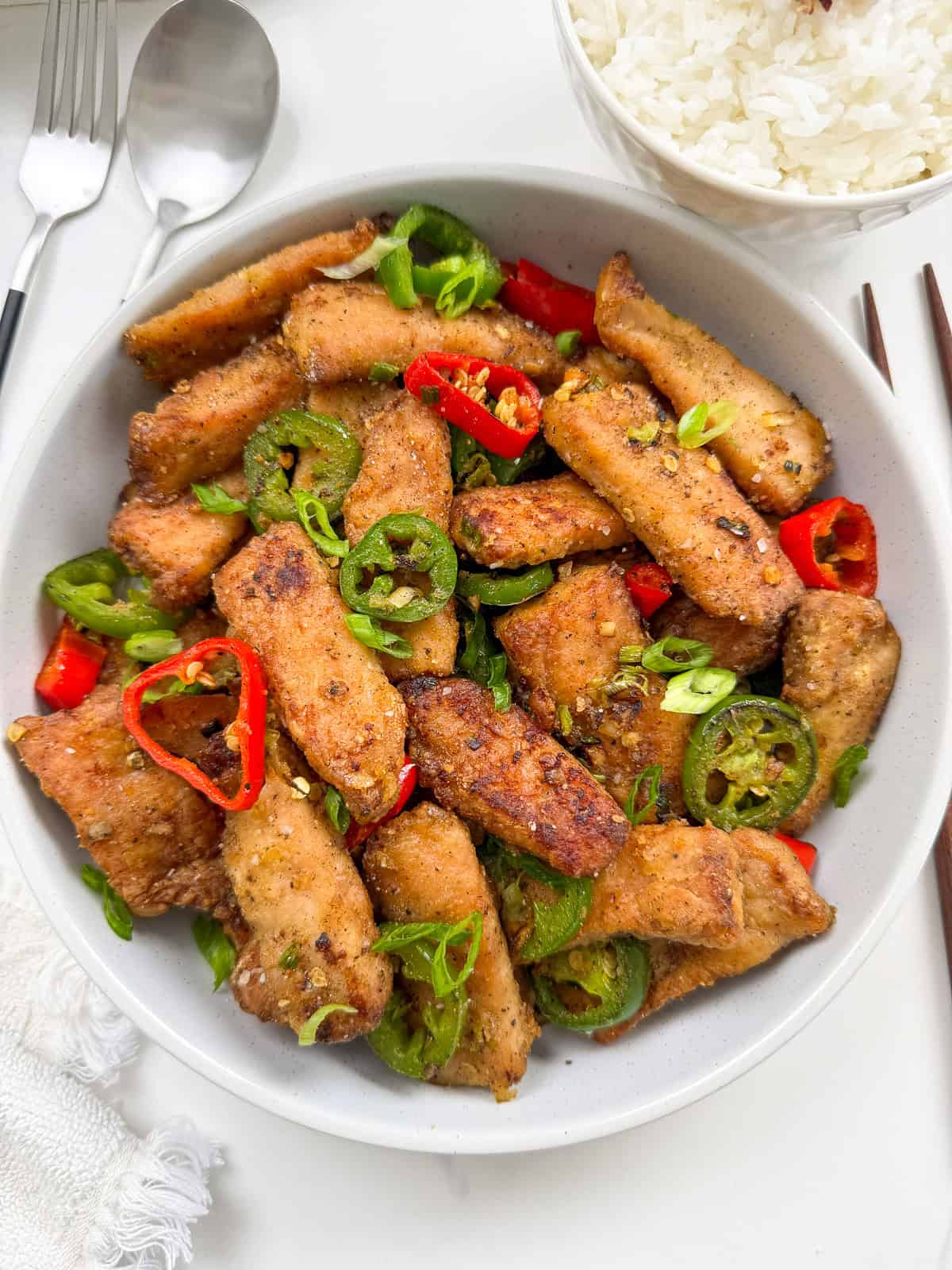 Salt and Pepper Pork Chops on a plate with peppers