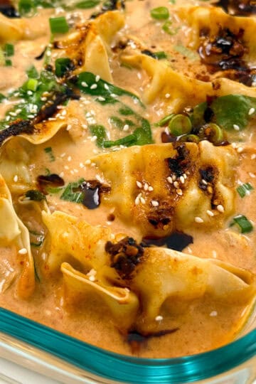 Dumpling Bake (Viral One Pan Recipe) in a baking dish with sauce featured view