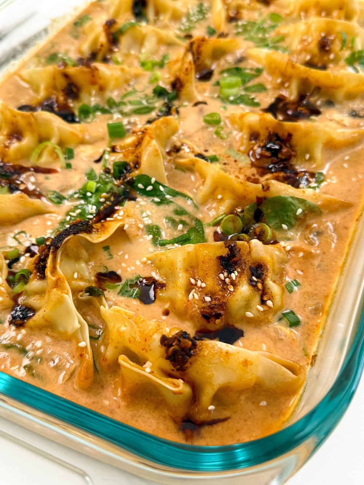 Dumpling Bake (Viral One Pan Recipe) in a baking dish with sauce side view
