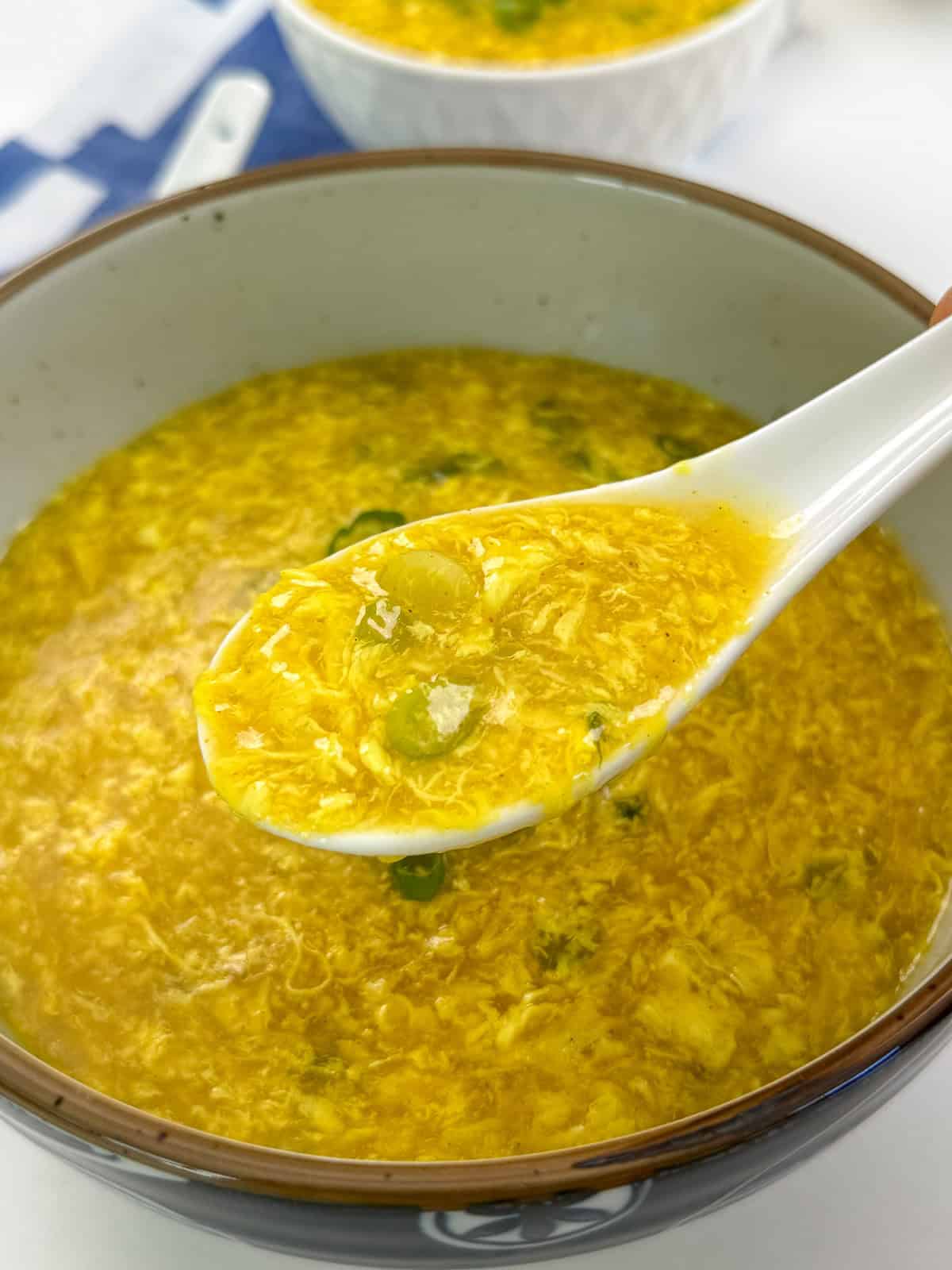 Easy Egg Drop Soup with spoon side view