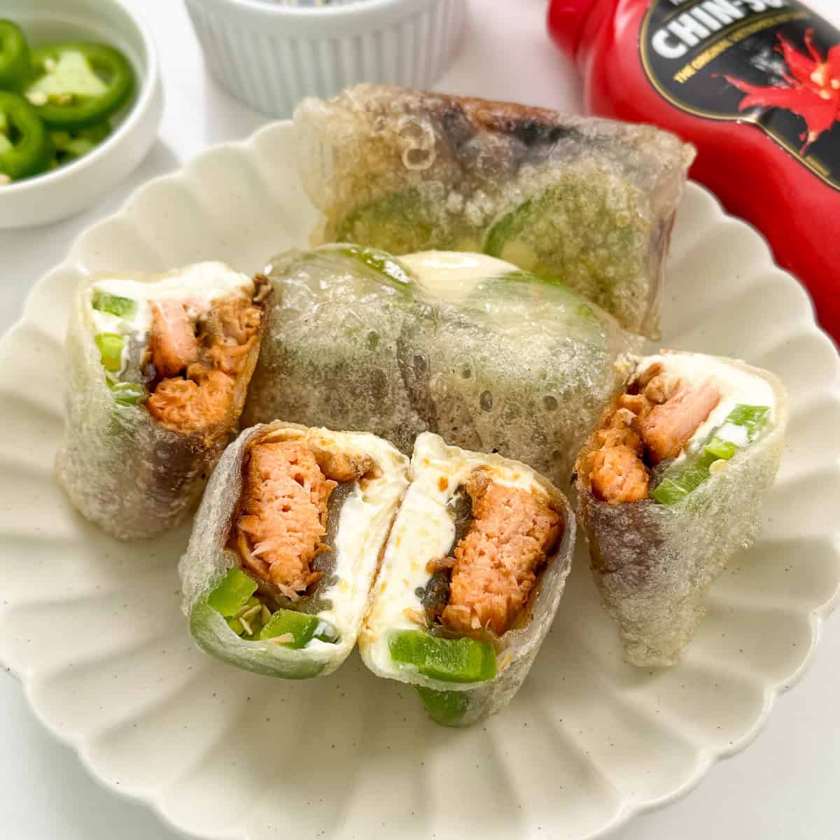 Jalapeno Salmon Cream Cheese Rice Paper Dumplings on a plate featured view