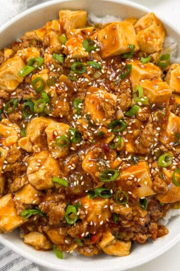 Mapo Tofu Recipe on top of white rice in a bowl featured view