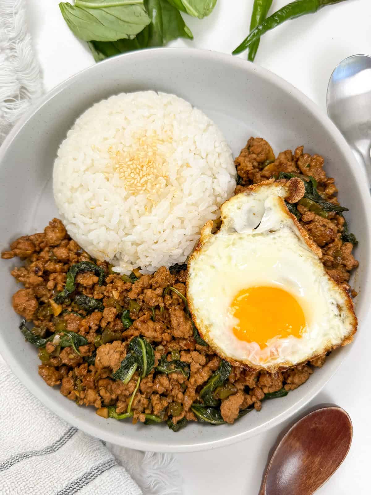 Pad Kra Pao (Ground Pork & Holy Basil Stir-Fry) in a bowl with white rice top view