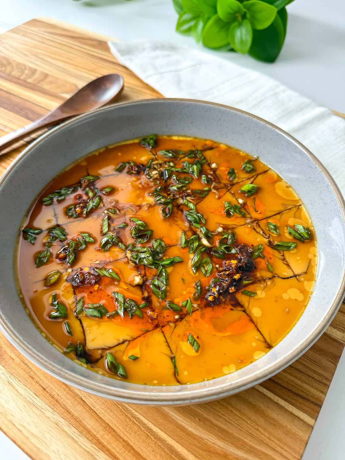 Steamed Eggs in a bowl with soy sauce and chili oil side view