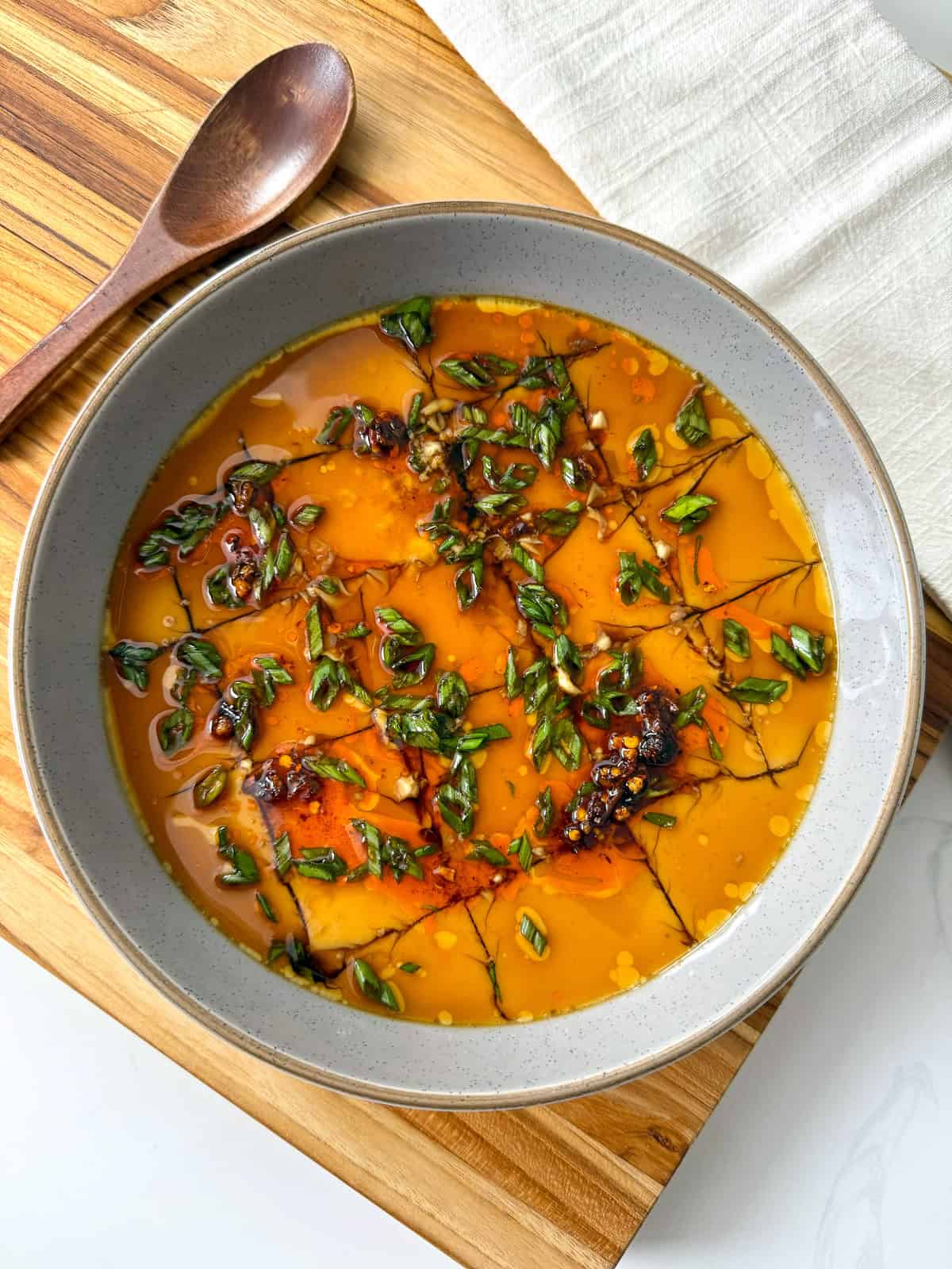 Steamed Eggs in a bowl with soy sauce and chili oil top view