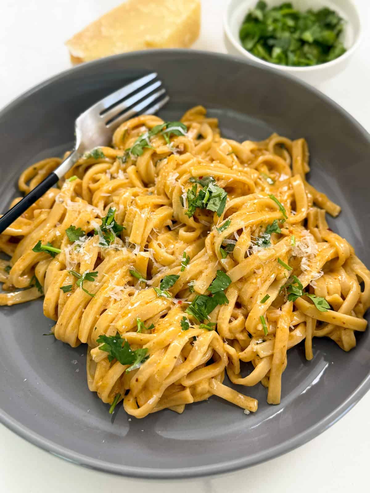 Garlic Butter Noodles on a plate with a fork side view