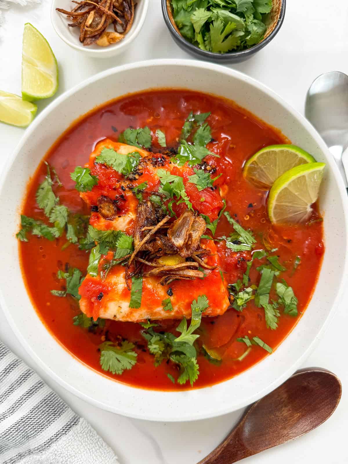 Tomato Poached Fish with Shallot Oil in a bowl top view