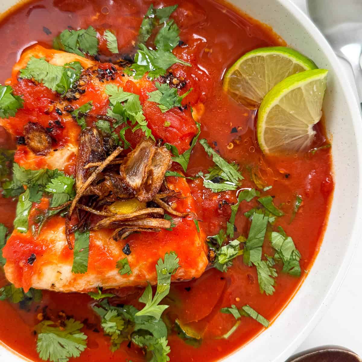 Tomato Poached Fish with Shallot Oil in a bowl featured view