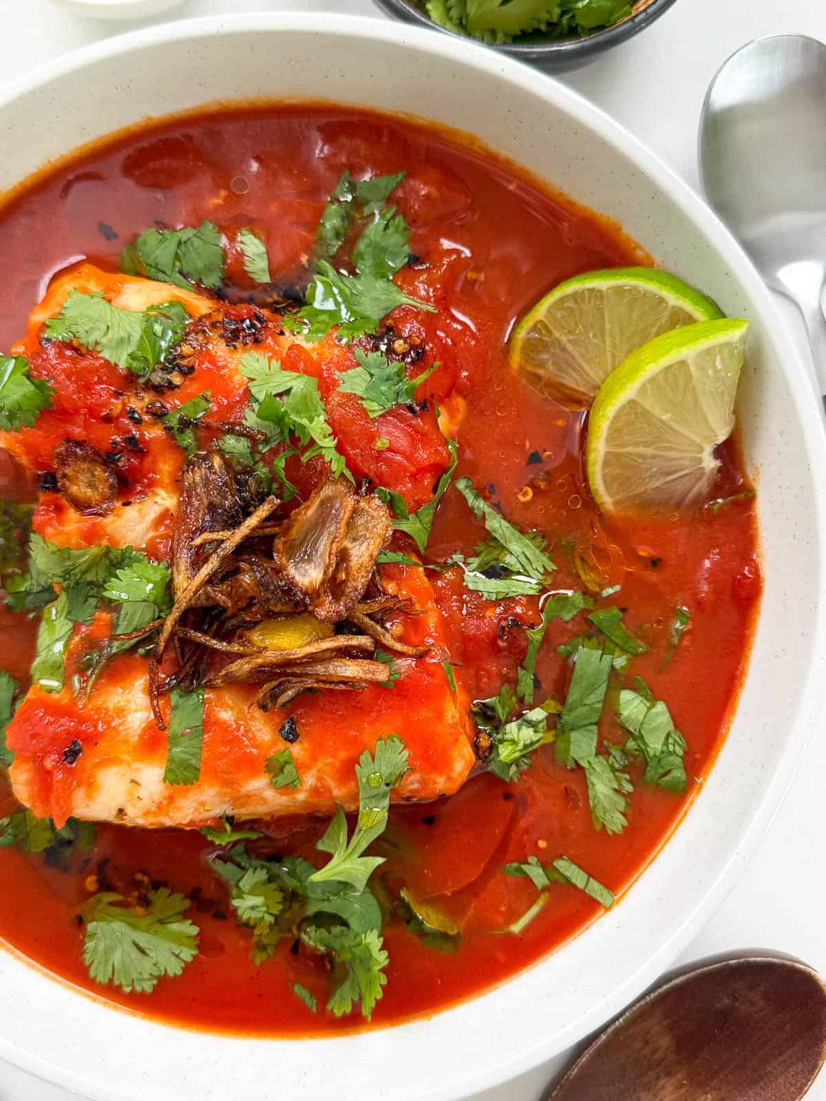 Tomato Poached Fish with Shallot Oil in a bowl main view