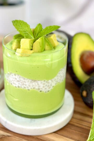 Avocado sago in a cup with avocado chunks and mint leaf on top