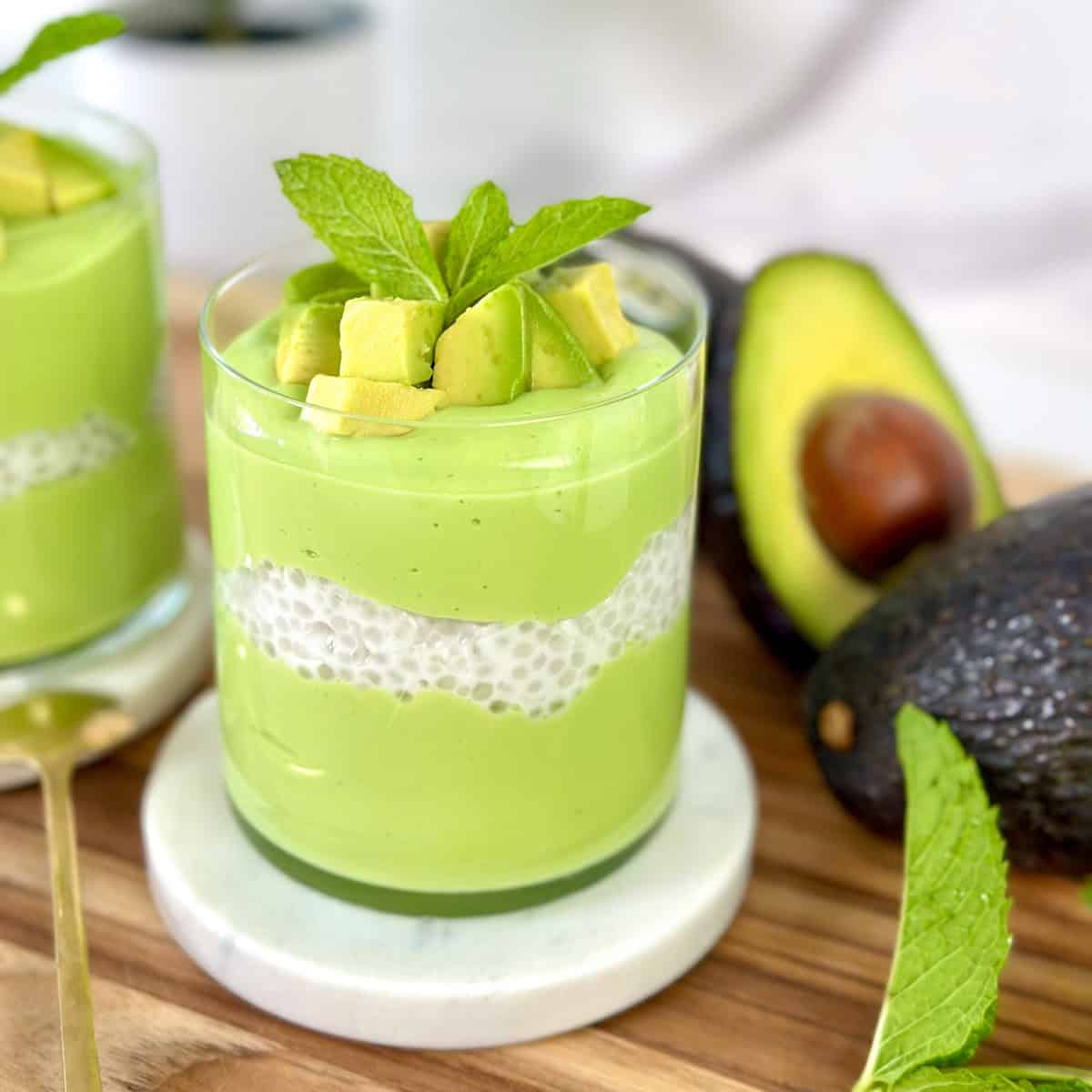 Avocado sago in a cup with avocado chunks and mint leaf on top