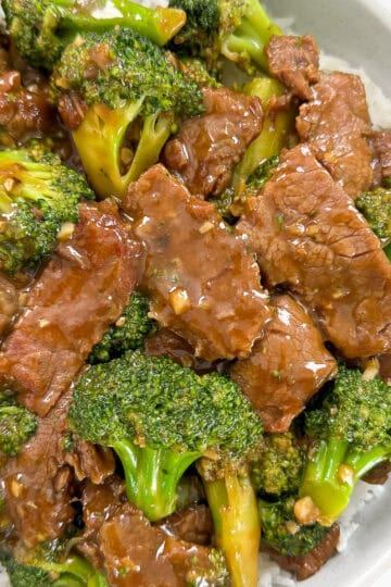 Beef and broccoli over rice in a bowl featured view