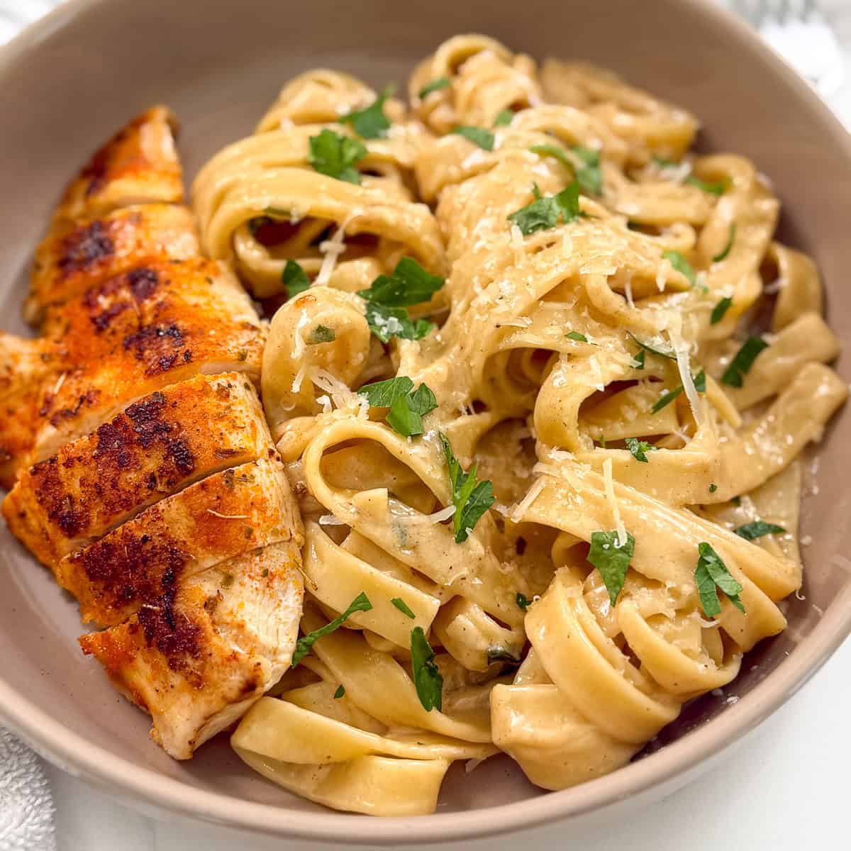 Chicken fettuccine alfredo in a bowl featured view