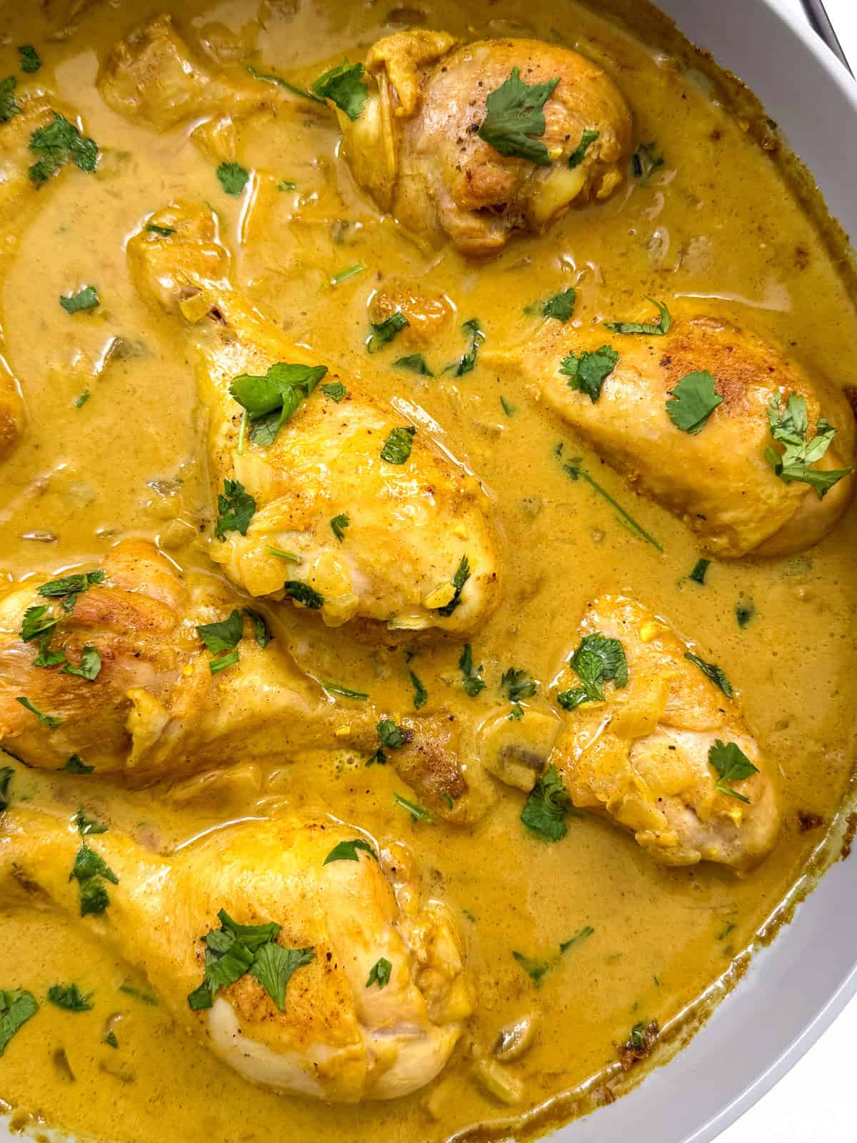 Coconut curry chicken in a large pan main view