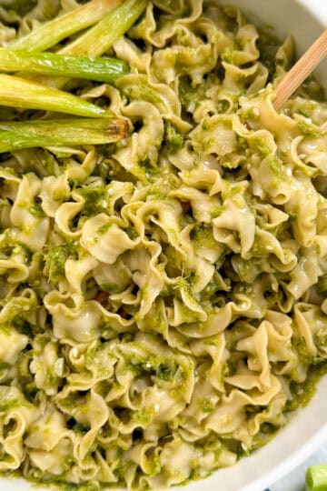 Ginger scallion noodles in a bowl with chopsticks featured view