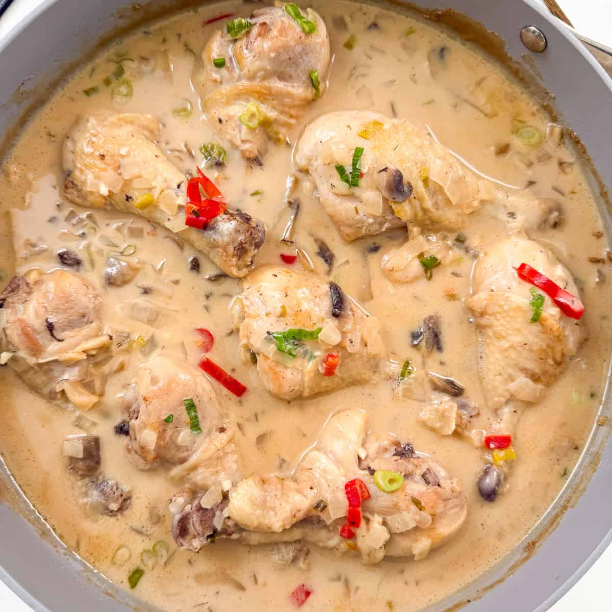 Chicken drumsticks simmered in a fragrant coconut lime broth with red chilis and green onions.