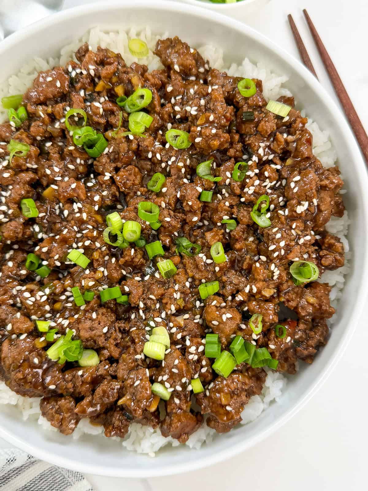 Mongolian ground beef over white rice in a large bowl main view