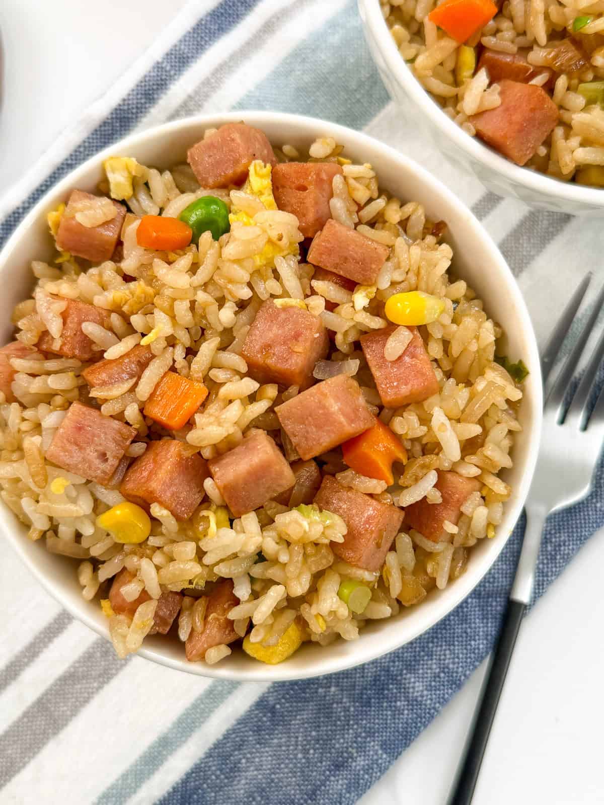 Spam fried rice top down view with a form on the right on top of a blue towel