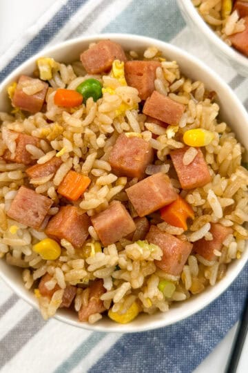 Spam Fried Rice top down view with a fork on the right side on top of a towel