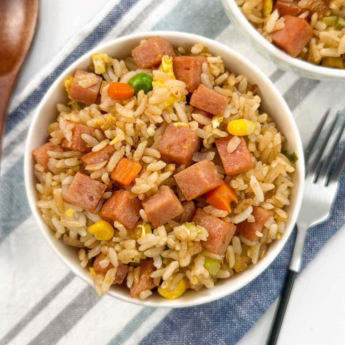 Spam Fried Rice top down view with a fork on the right side on top of a towel