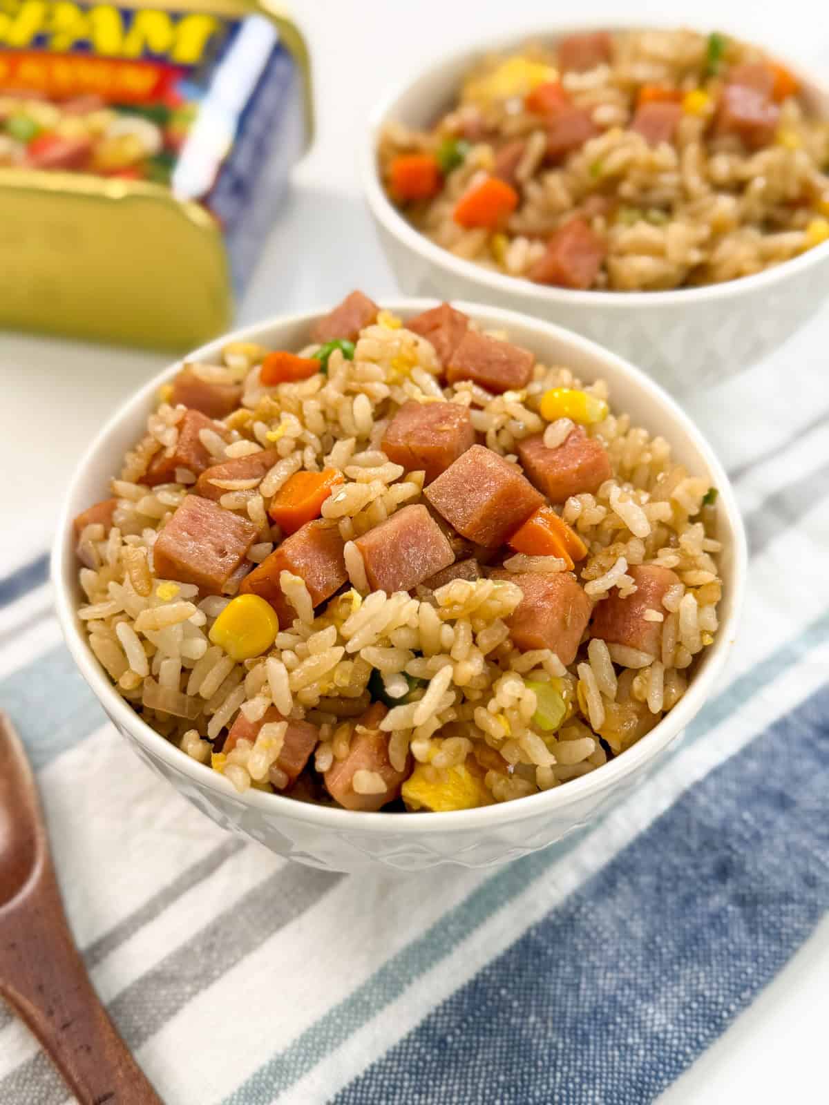 Spam Fried Rice in a bowl on top of a towel with a spoon