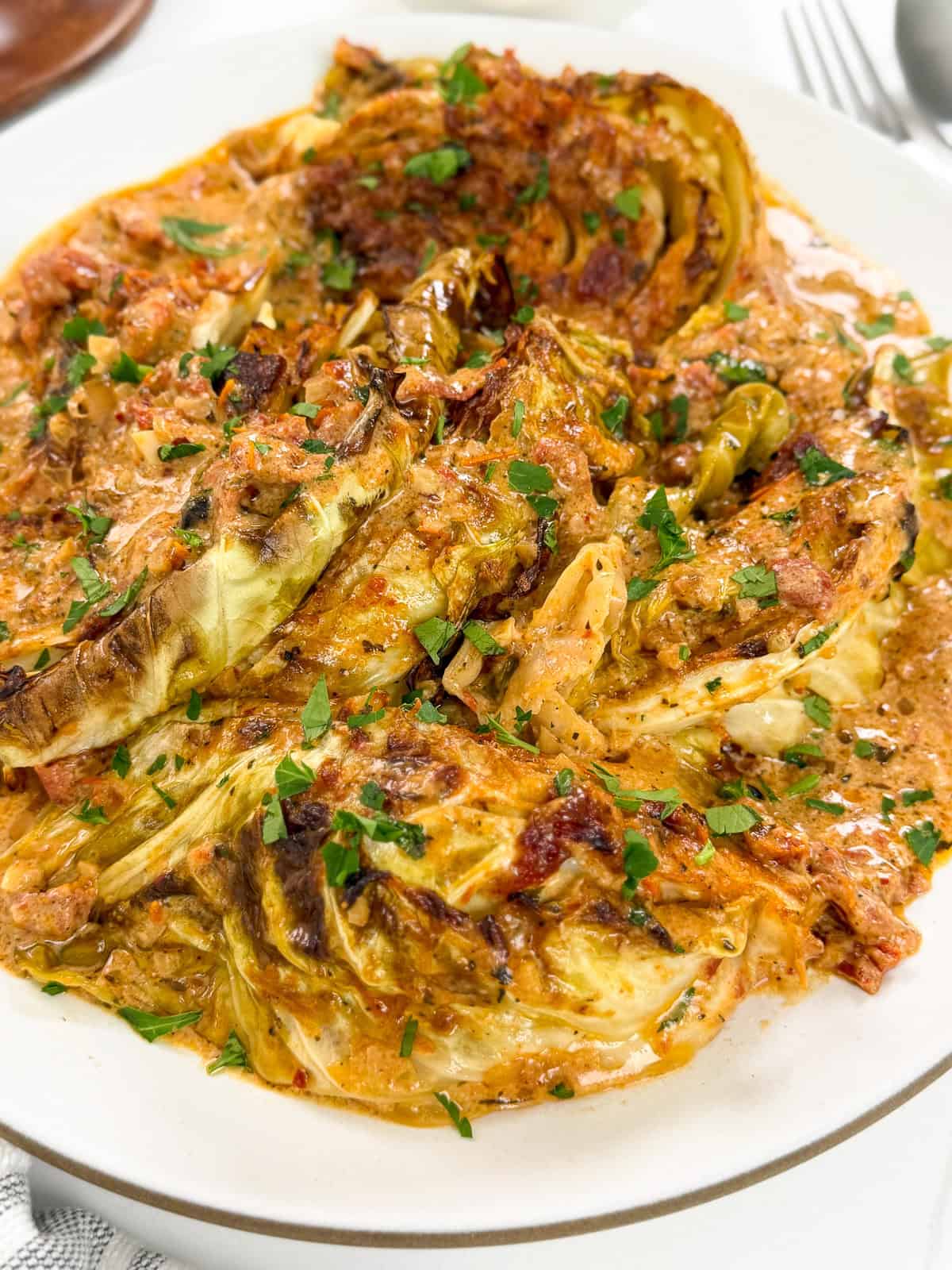 Marry Me Melting Cabbage on a white plate with parsley on top